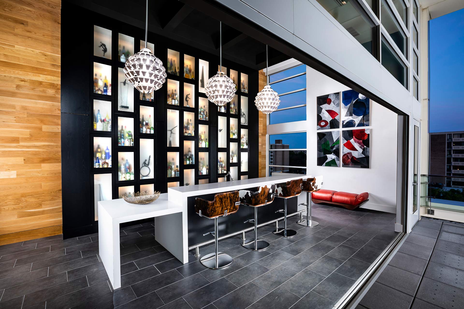 The Wine Bar features convenient bar appliances with a covertible view of the terrace and Southwest waterfront beyond.